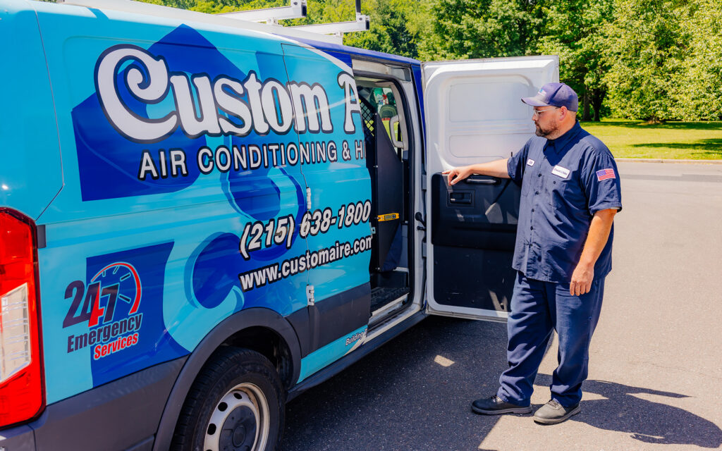 Joe looking inside of custom wrapped Custom Aire van