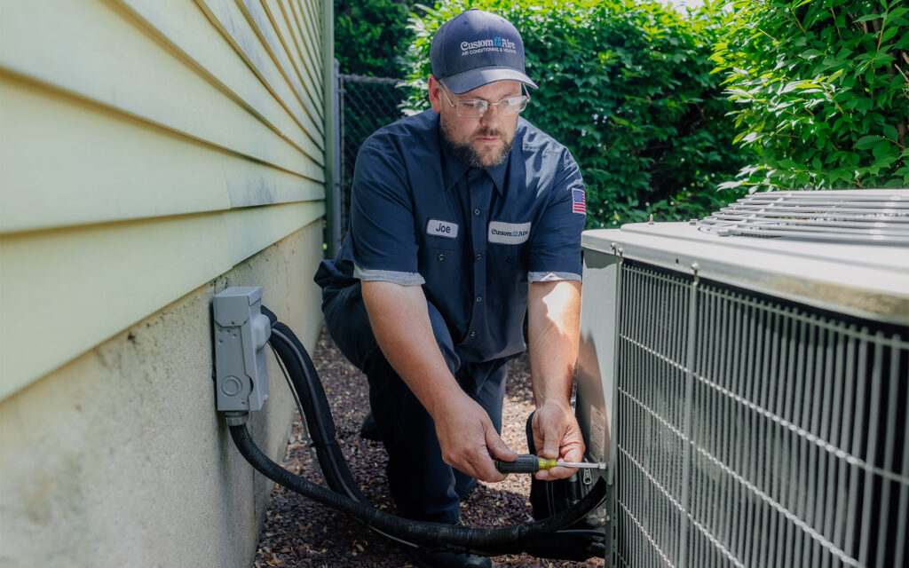 Joe using tools to work on residential cooling unit