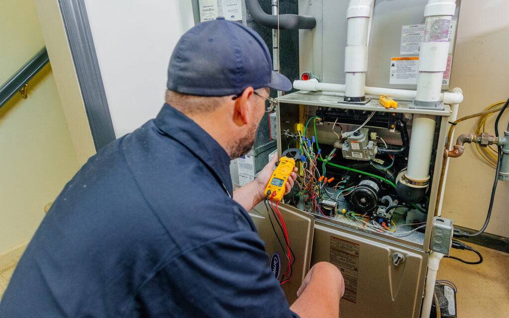 Worker using a gauge to work on residential HVAC