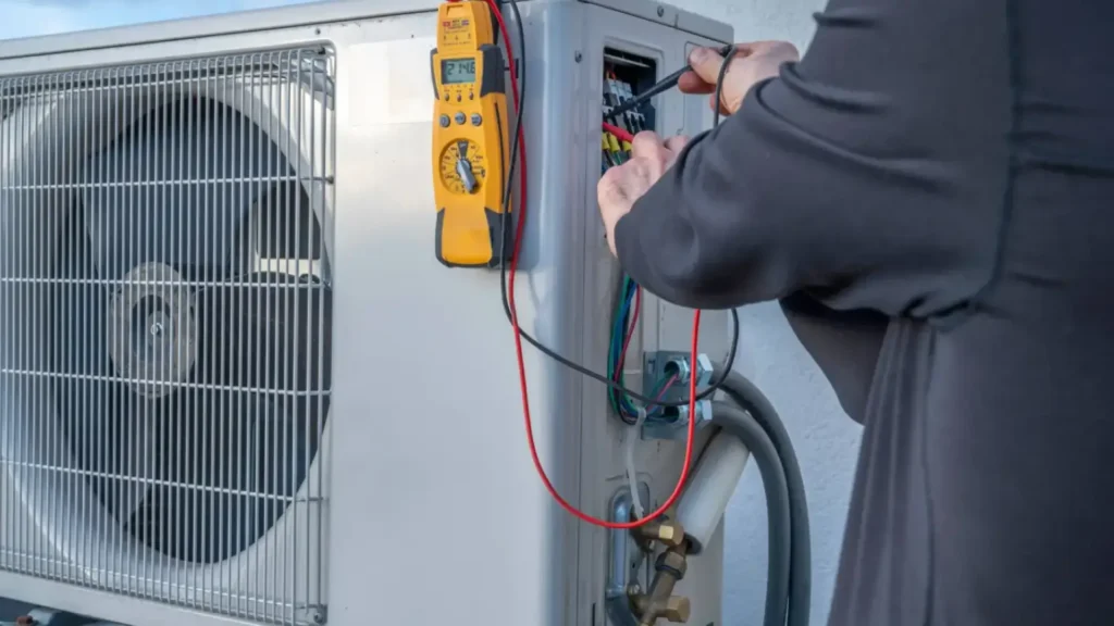 person using tools to work on roof hvac unit