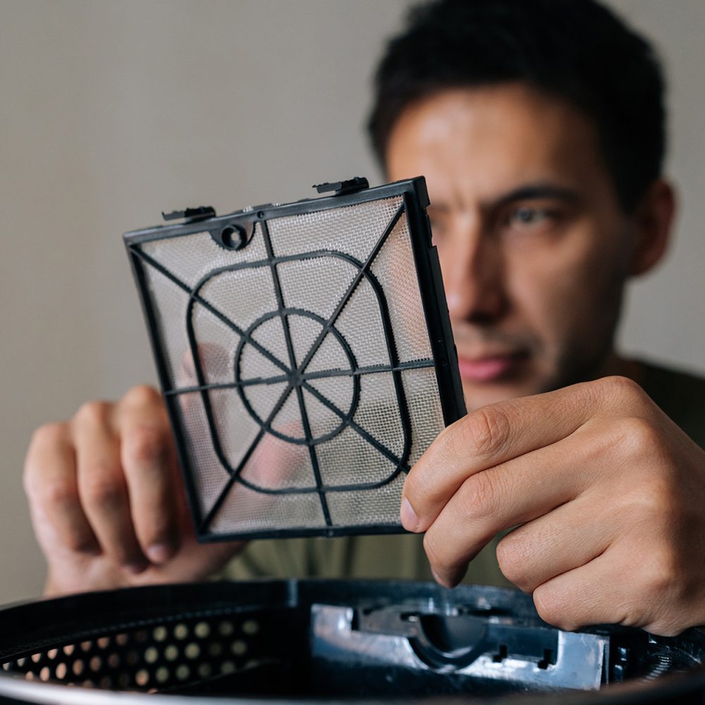 Man checking air humidifier filter